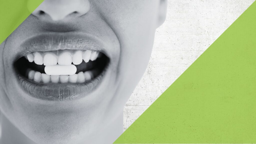 Woman with pill/capsule between her teeth