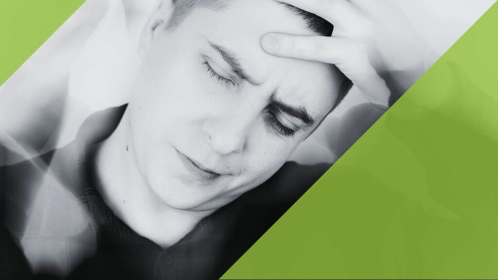 Man with closed eyes leaning on one hand
