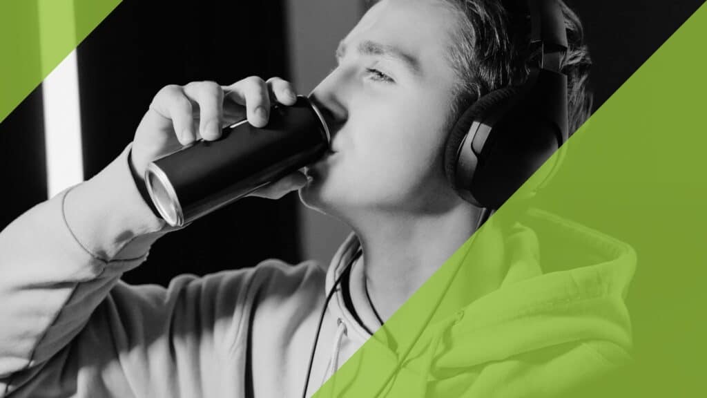 Young man with headphones, drinking a can of energy drinks